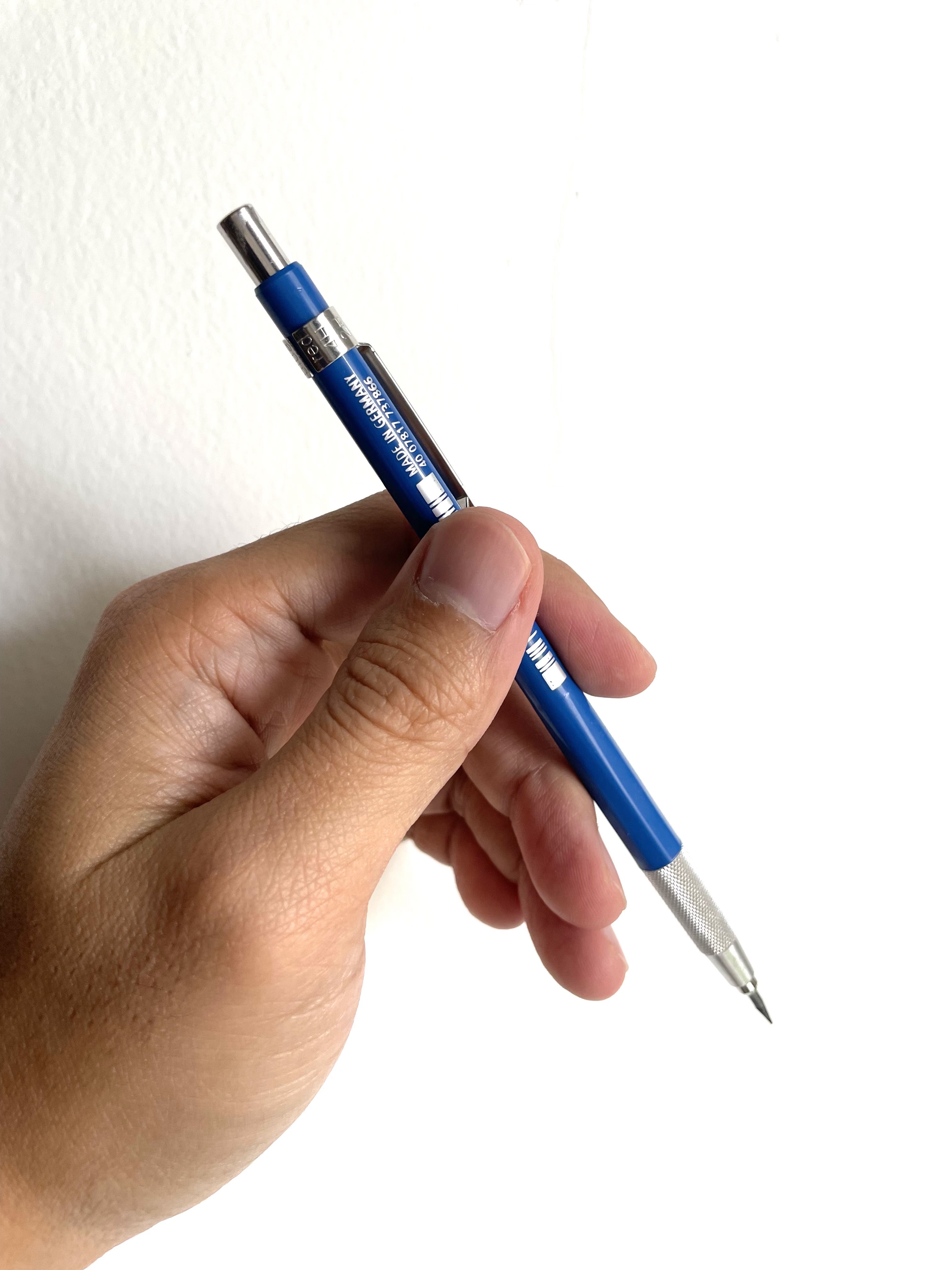A blue Faber-Castell mechanical pencil held in hand against a clean white background.